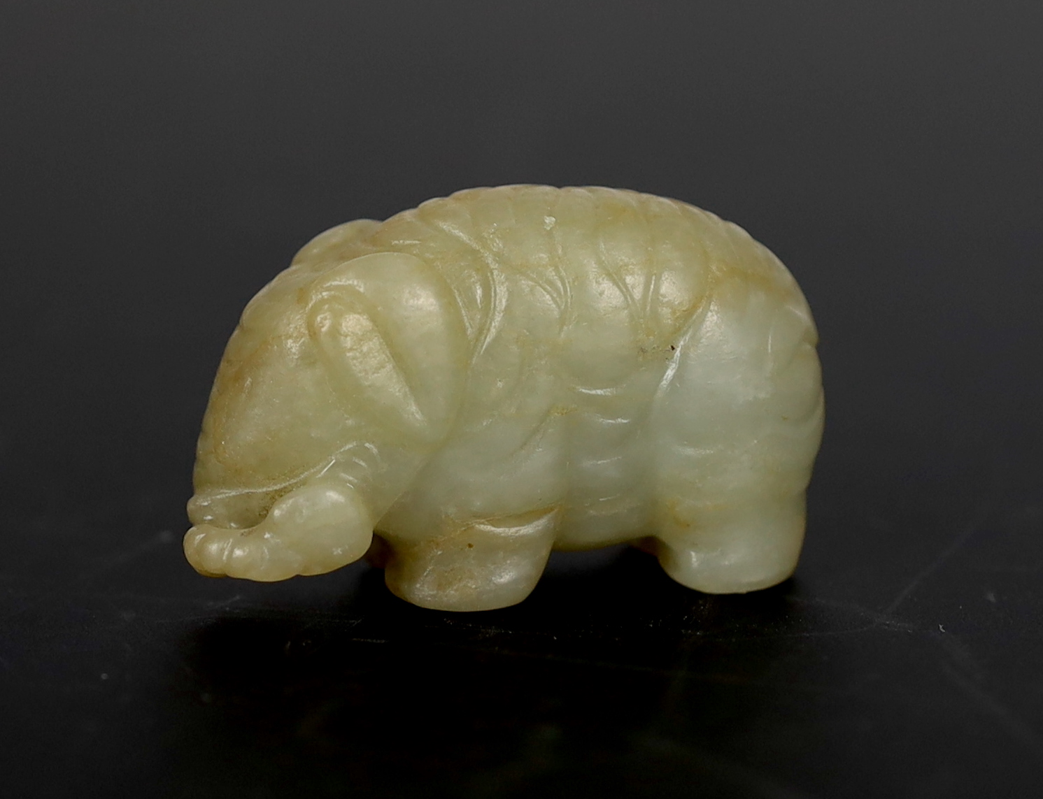 A Chinese small mellow green jade model of a standing elephant, 17th century